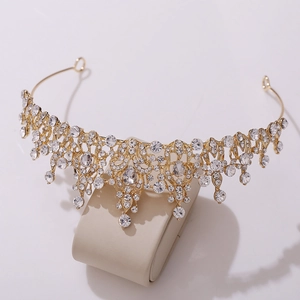 Detailed macro view of gold crystal bridal tiara with sparkling pear-shaped rhinestones