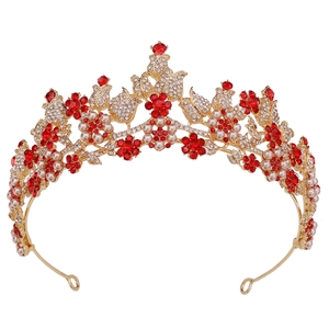 Detailed view of bridal crown with red floral crystals, pearls, and rhinestones