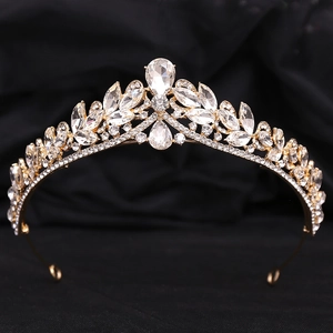 Luxury bridal crown with gold plating and sparkling crystals on black velvet background