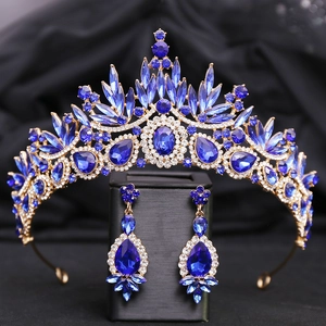 Detailed close-up of Baroque gold crown and earrings with luxury deep blue sapphire stones