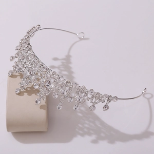 Macro view of silver bridal tiara with sparkling crystal teardrop pendants and intricate metalwork
