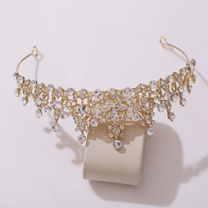 Close-up of golden bridal tiara with sparkling crystal rhinestones and baroque details