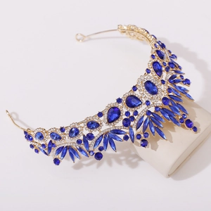 Detail of a baroque bridal crown with deep blue crystals and gold leaf alloy settings