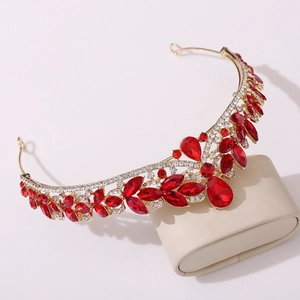 Detail of a luxury bridal crown with large red crystals and sparkling white rhinestones