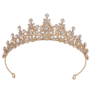 Close-up of golden bridal tiara with sparkling crystal rhinestones and fixing loops