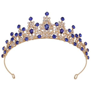 Detailed close-up of a bridal tiara featuring blue teardrop stones and white crystals