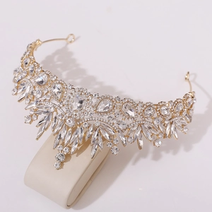 Detailed view of Baroque bridal crown featuring crystal leaves on a gold stand
