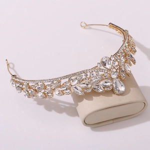 Detail of golden bridal crown with marquise crystals and pear-shaped drop pendant