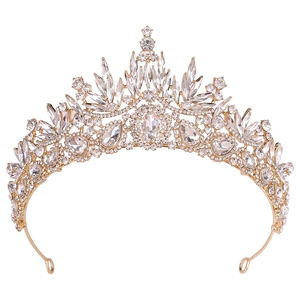 Detailed close-up of Baroque gold crown featuring clear crystals and leaf motifs