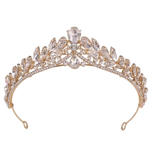 Detailed macro view of golden bridal crown with teardrop crystals and leaf patterns