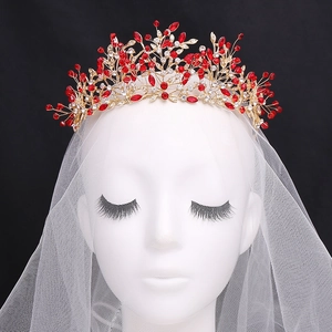 Elegant bridal crown featuring golden leaves, red crystals and a white wedding veil