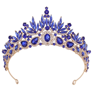 Detailed view of Baroque gold crown with large navy blue crystals and leaf motifs