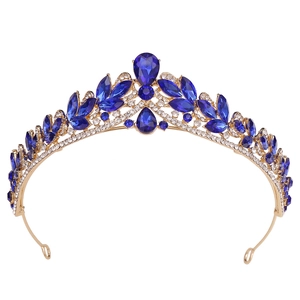 Detailed close-up of Baroque bridal crown with teardrop blue crystal and gold alloy