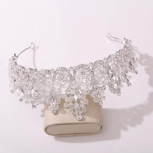 Macro shot of silver Baroque bridal tiara with intricate crystals on a leather stand