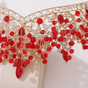 Detail of a gold bridal crown with red beaded tassels and sparkling crystals