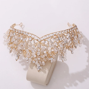 Close-up of golden bridal tiara with floral patterns and sparkling crystal rhinestones