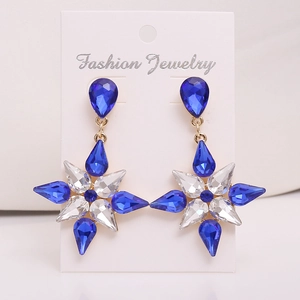 Gold snowflake earrings featuring blue teardrop crystal and star pendant for women