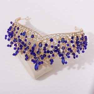 Macro detail of bridal crown featuring navy blue crystals and rhinestones on gold alloy