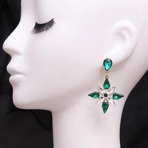 Elegant gold alloy snowflake earrings with green and white crystals on a model