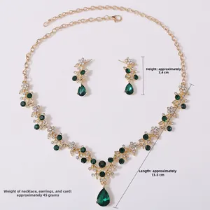 Detailed macro view of gold-tone bridal necklace and green teardrop earrings set