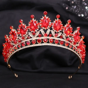 Close-up of red crystals and rubies on a gold leaf bridal crown for wedding hair
