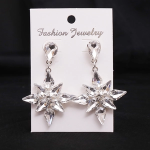 Close-up of alloy snowflake earrings with clear pear-shaped crystals on display card
