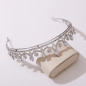 Detailed macro shot of silver bridal crown with intricate zircon and rhinestone pavé settings