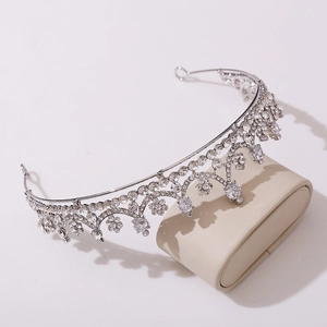 Detail view of silver bridal crown featuring sparkling zircon floral and arch patterns