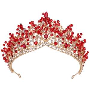 Detail of handmade gold bridal crown with luxury red crystal beads and sparkly rhinestones