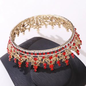 Close-up of golden crown with red rhinestones and clear crystals for bridal wear