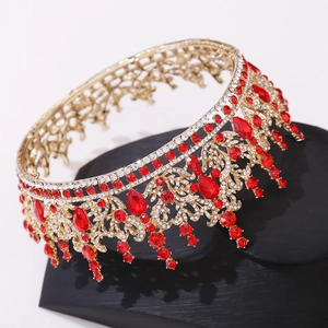 Detailed view of Baroque bridal crown with red gemstones and crystals on a black stand