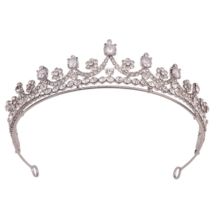 Detail of silver bridal tiara featuring wave-patterned rhinestones and large central crystal