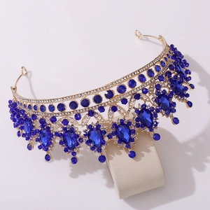 Detailed macro shot of baroque gold bridal crown with deep blue crystals and rhinestones