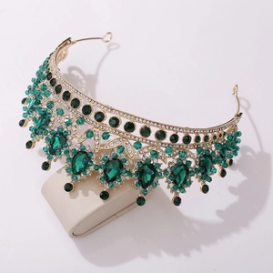 Detail of emerald crystal bridal crown with waterdrop pendants on a gold frame