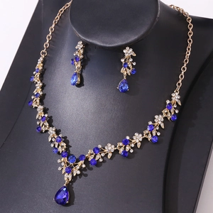 Elegant gold bridal jewelry set with deep blue teardrop crystals and matching earrings