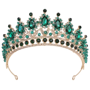 Detailed close-up of emerald green crystal crown with golden alloy and white rhinestones