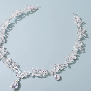 Detail of silver bridal headband with crystal floral patterns and teardrop pendants