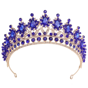 Classic gold bridal crown with deep blue crystals and white rhinestones on white backdrop