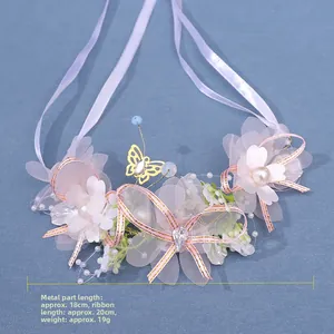 Detail of bridal floral headband with white lace flowers, pearls and pink silk ribbons