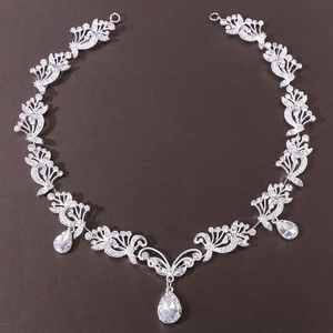 Detail of silver bridal hair band with white crystals and three pear-shaped drops