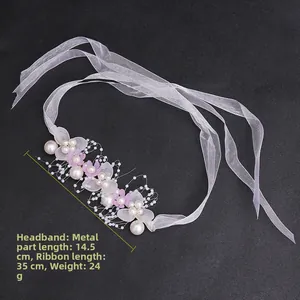 Detail of pink floral crown with pearls, metal weaving and long organza ribbons