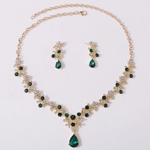 Detailed view of bridal rhinestone necklace set with green teardrop pendants and gold plating