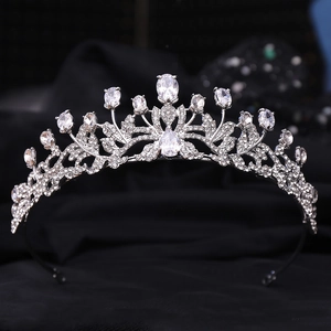 Macro shot of silver bridal crown featuring leaf vine design with sparkling cubic zirconia