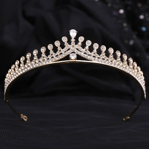 Detailed close-up of a bridal gold crown with AAA zircon and drop-shaped crystal on black velvet