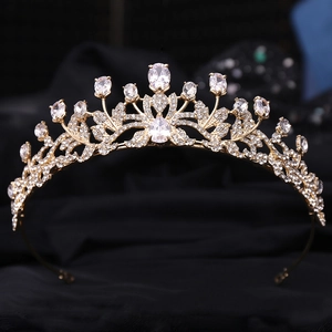 Detailed close-up of intricate hollow leaf gold crown with shimmering zircon crystals