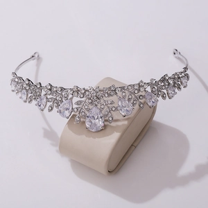 Close-up of silver bridal tiara with leaf-shaped AAA zircon and teardrop crystals