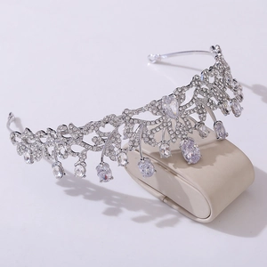 Detail of silver bridal crown with zircons and leaf patterns on jewelry stand