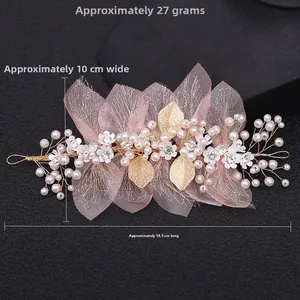 Detailed view of pink mesh bow floral hairpiece measuring 18.5cm by 10cm and 27g