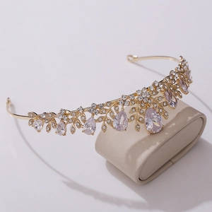 Detailed view of bridal crown with gold leaf design and teardrop zircon crystals