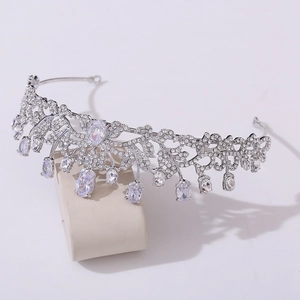 Macro detail of silver bridal crown with intricate hollow leaf design and water drop crystals
